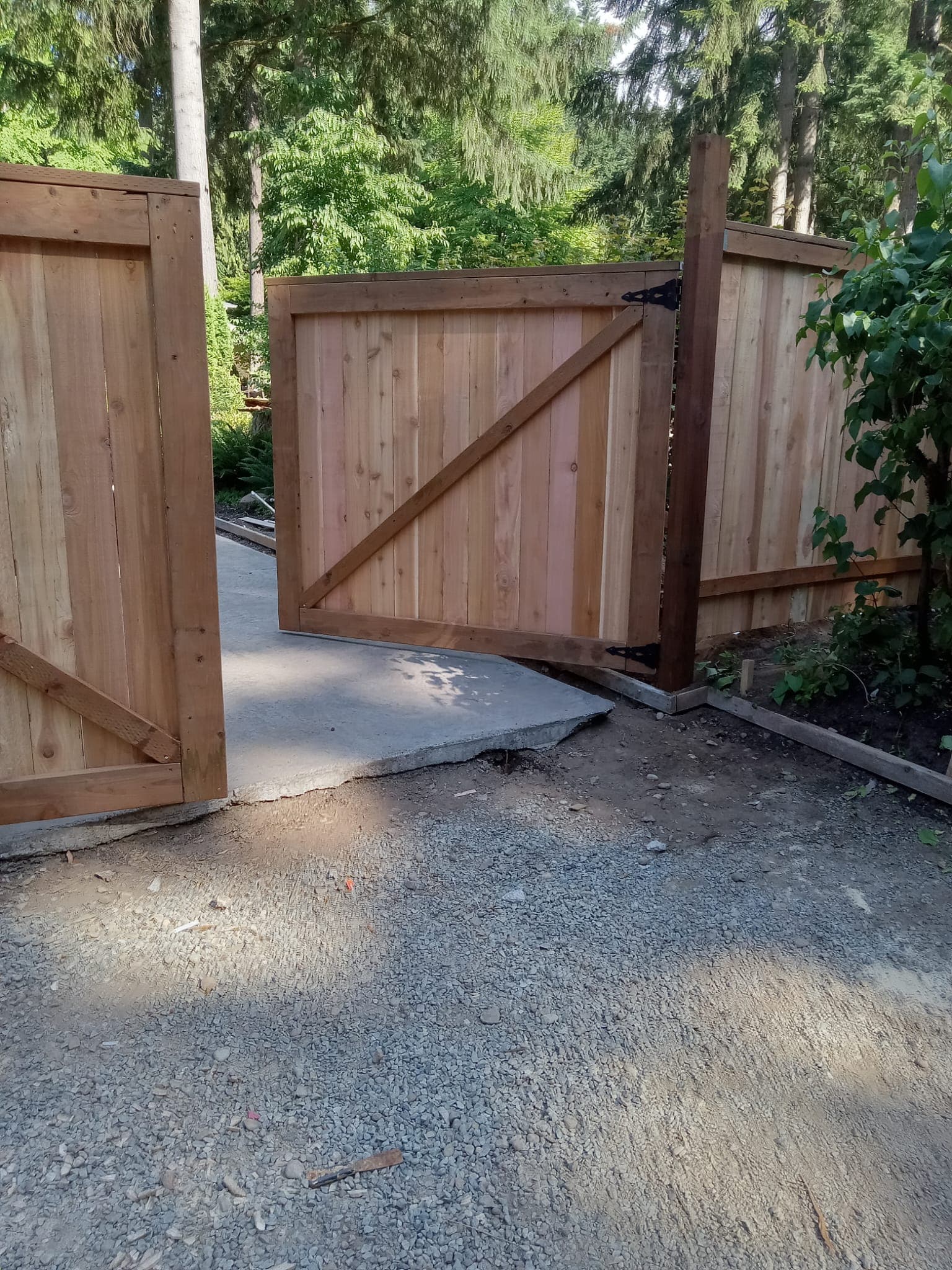 Cedar gate and concrete entry pad viewed from inside property