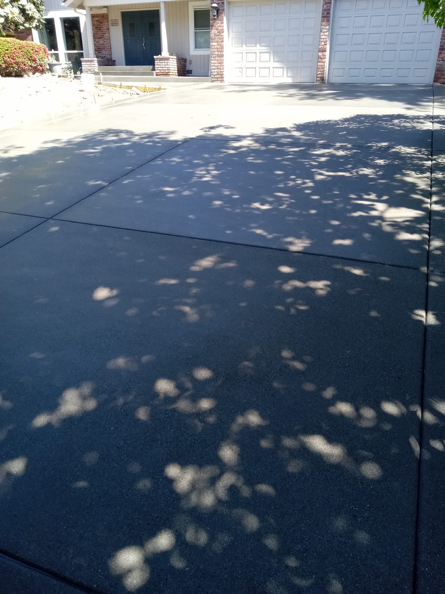 Broom-finished concrete driveway with clean control joint lines
