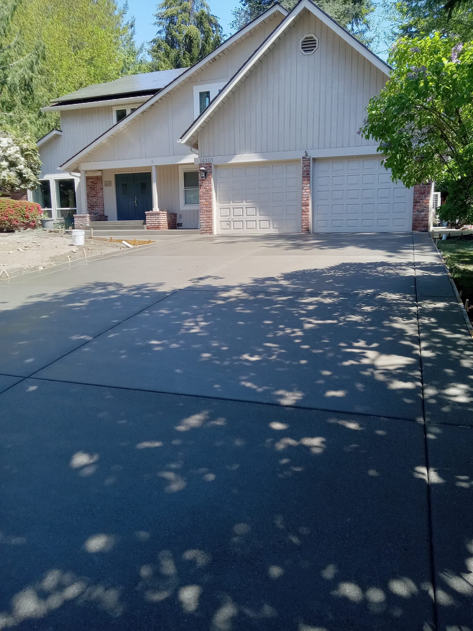 Smooth finished concrete driveway at residential home