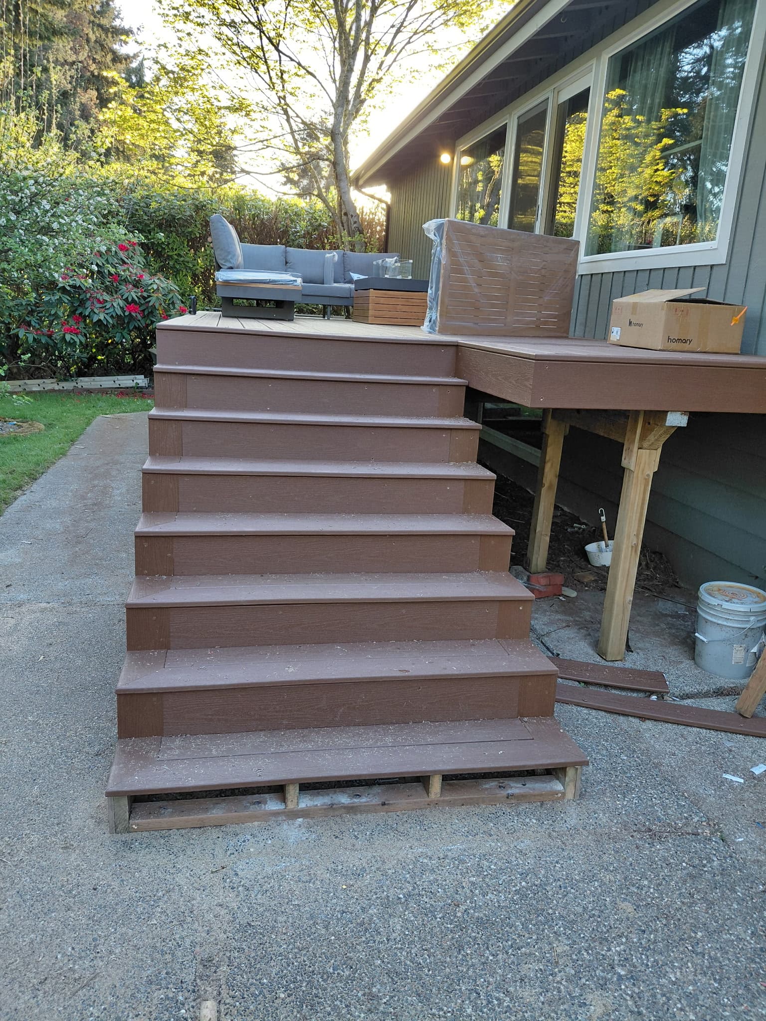 Finished composite deck stairs with warm wood tones at golden hour