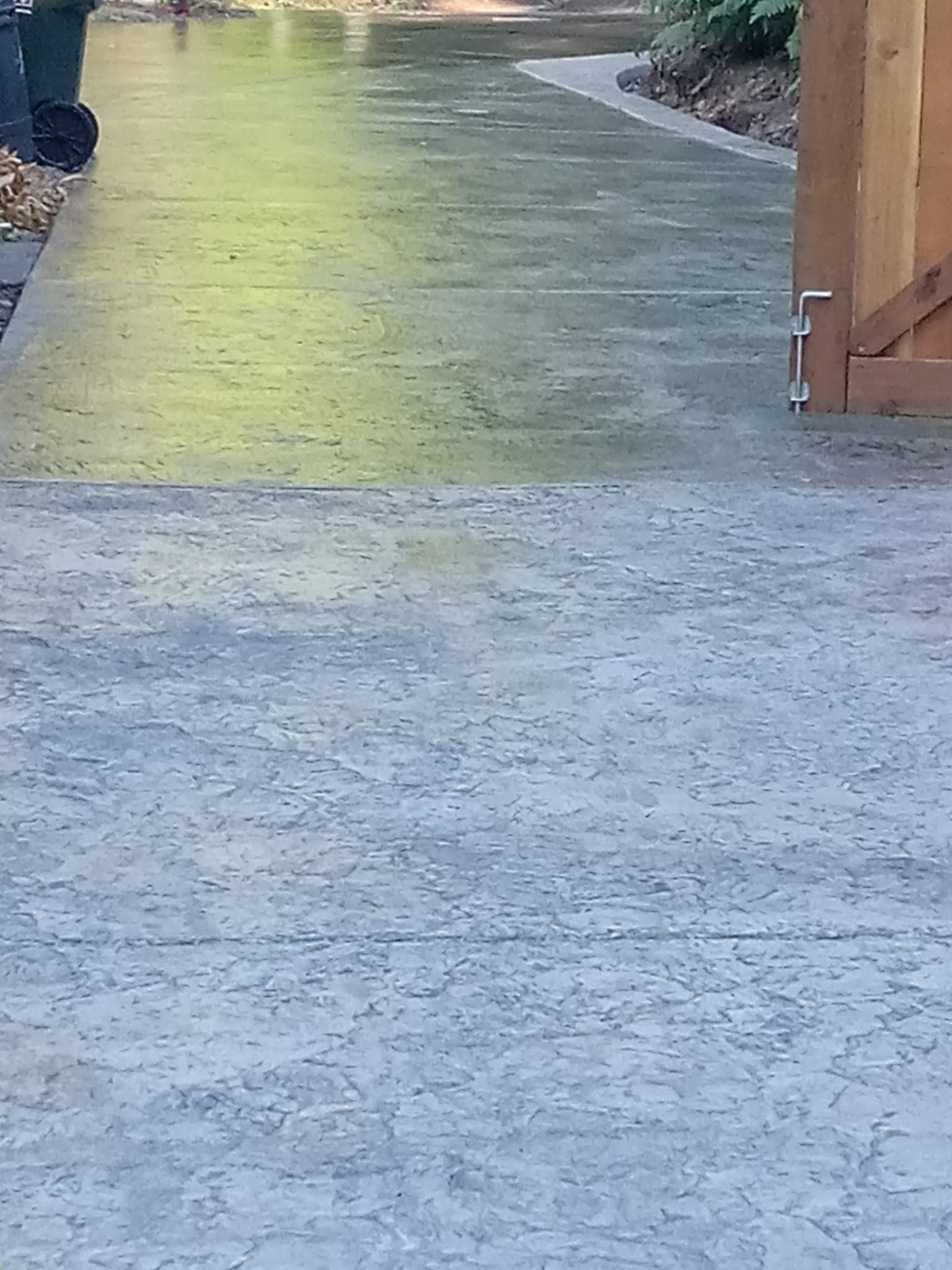 Stamped concrete driveway path with textured stone-look finish